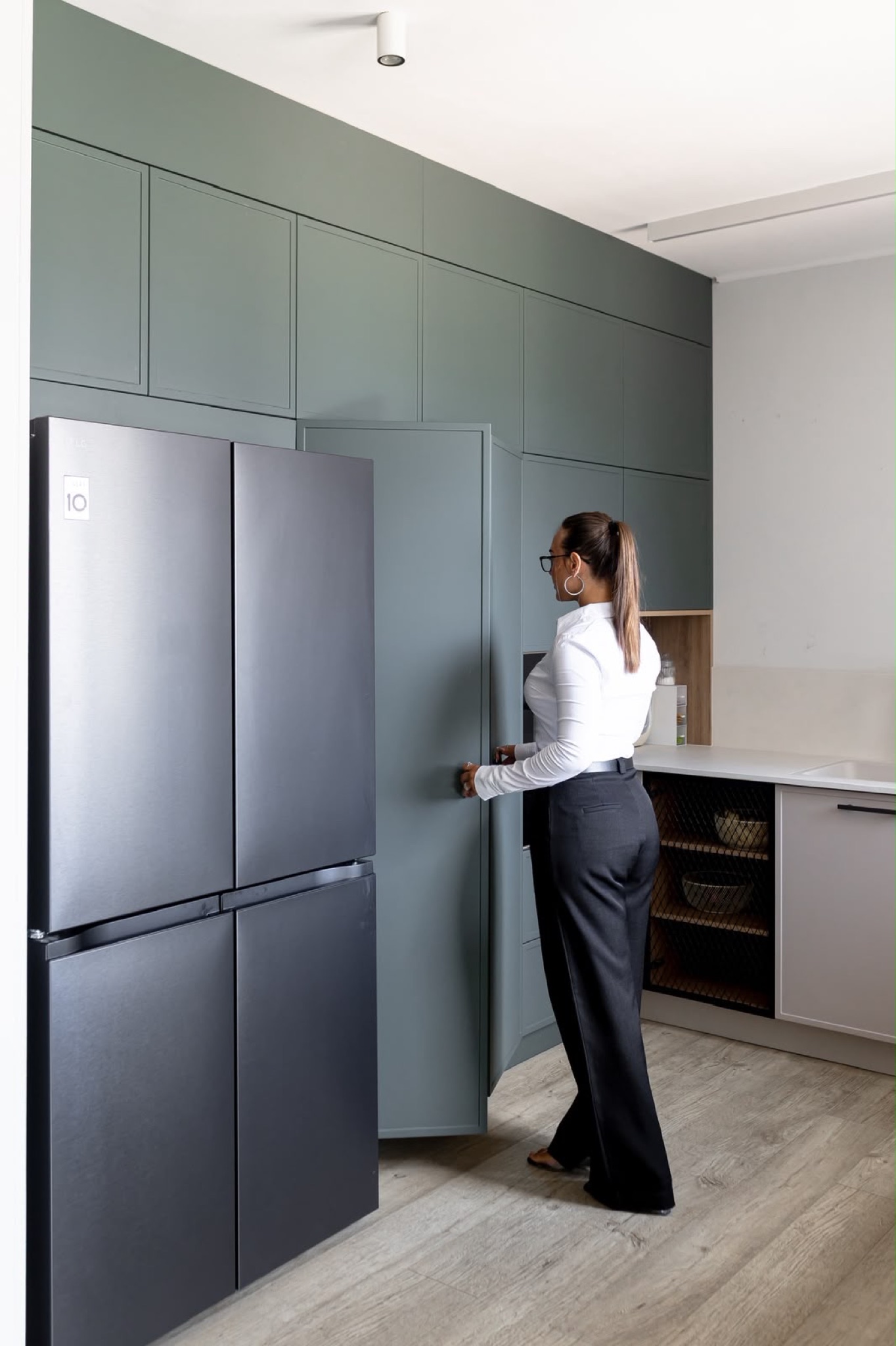 Portrait detail of the amber glass pendants above the stone worktop